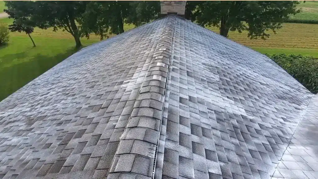 Discolored farmhouse roof in Gashill surrounded by trees, suggesting need for roof replacement.