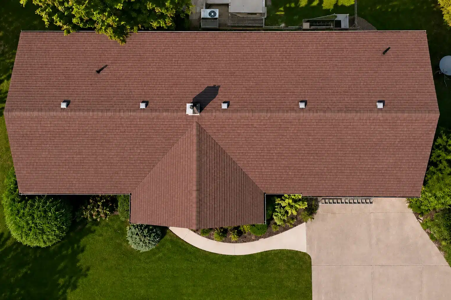Aerial view of red shingle roof house in Baden, Ontario with driveway, lawn, and trees.