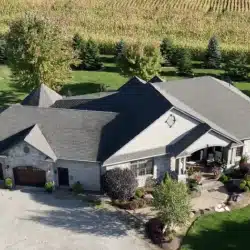 roof (1) Aerial view of a single-story home with a gray roof, suitable for roof rejuvenation services.