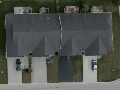 After Aerial view of a townhouse with a grey asphalt roof: After View