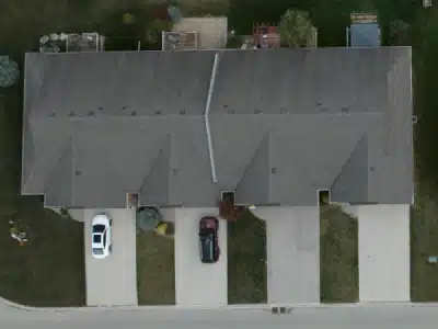 Before Aerial view of a townhouse with a grey asphalt roof: Before View