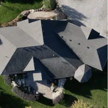 Aerial view of a large house with gray roof in Calgary.