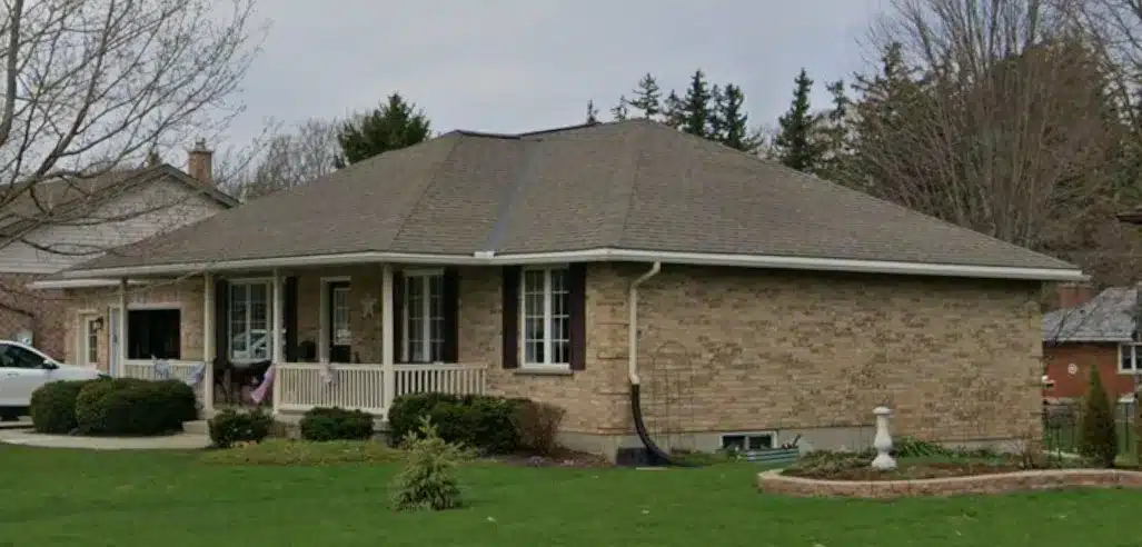 Milverton Bungalow: single-story brick house with hipped roof, porch, and landscaped green lawn.