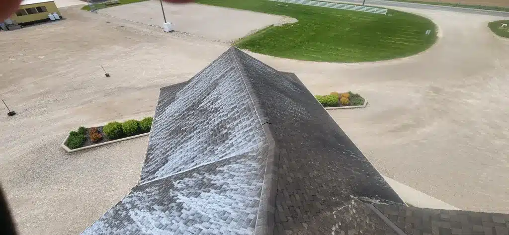 Worn shingled roof with missing shingles, aerial view over Donegal, Ontario landscape.